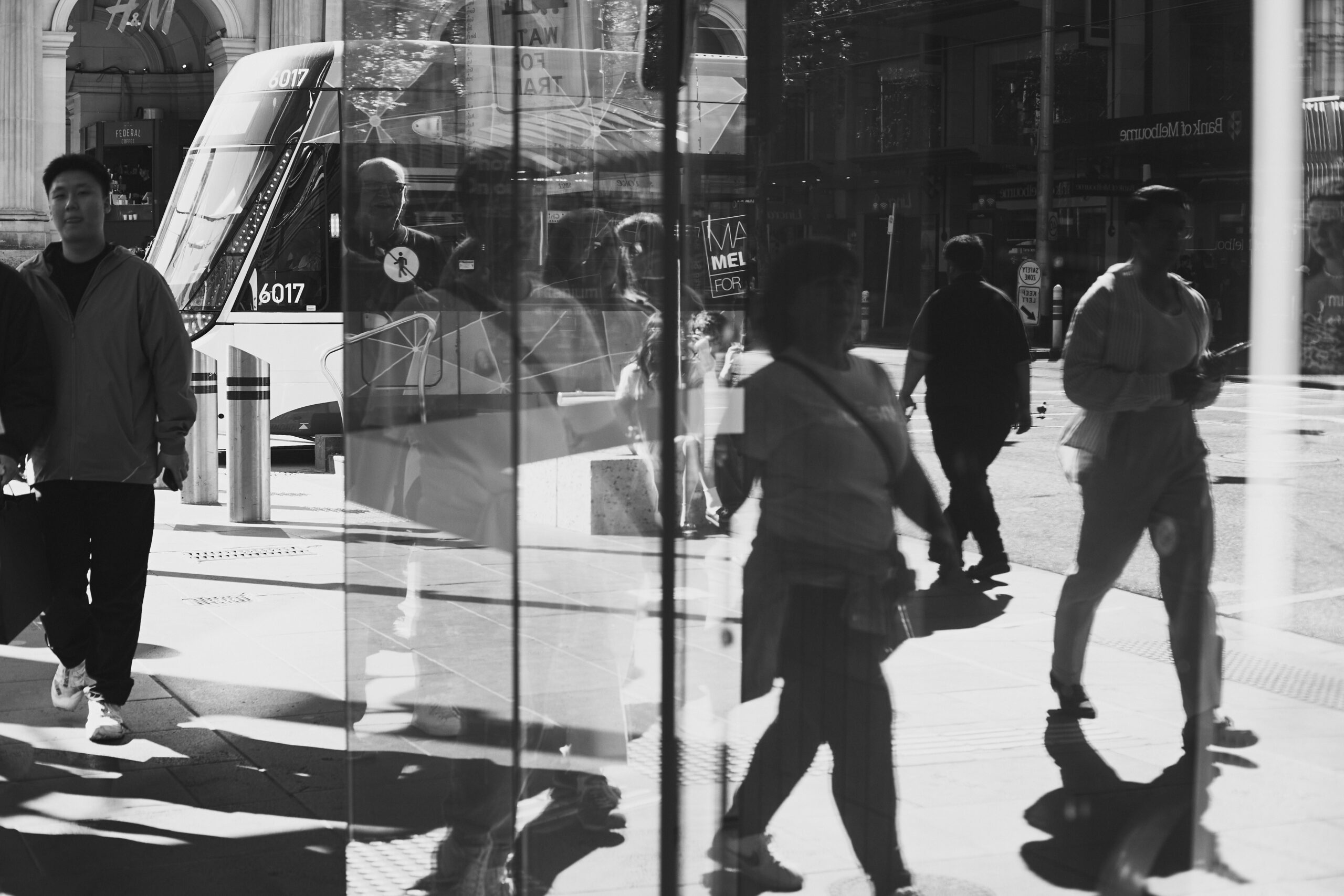 A black and white photo of people walking down a street. Taken By Aidan McCorry | Copyright Aidan McCorry Chromatic Times