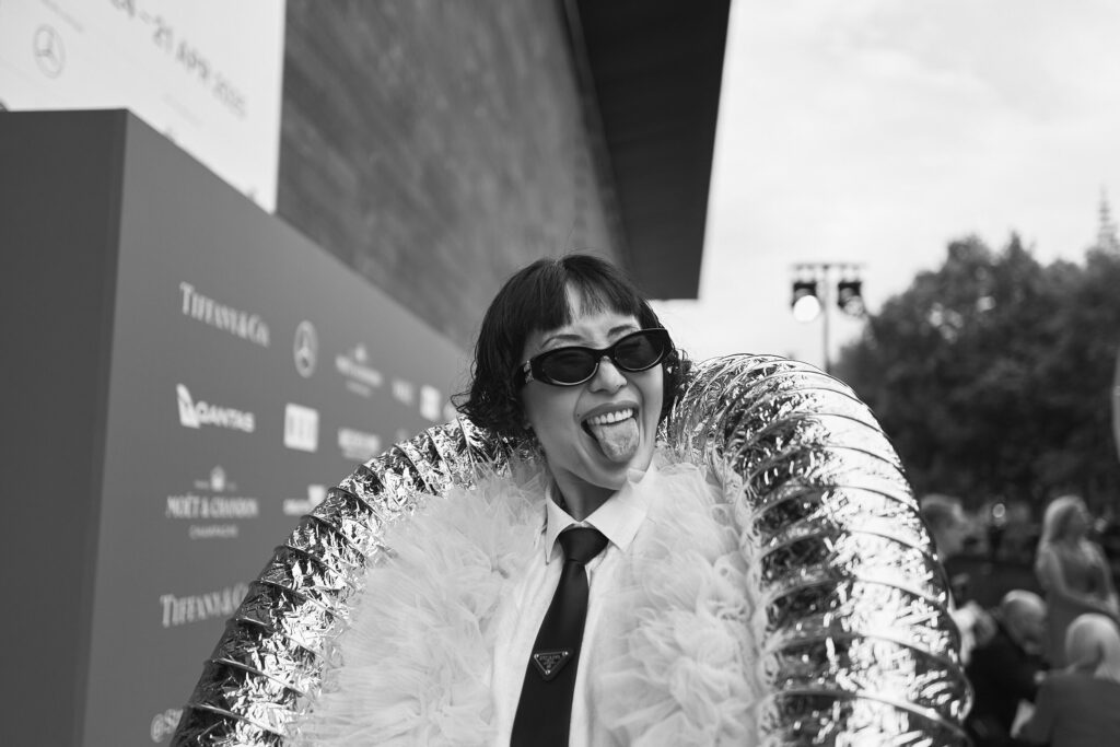 Charlene Ye Davis, Wearing a pink flamingo style jacket over the top of a White Business shirt and Prada Gabardine Tie, National Gallery of Victoria’s NGV GALA 2024. Chromatic Times Melbourne Fashion Photographer - Aidan McCorry