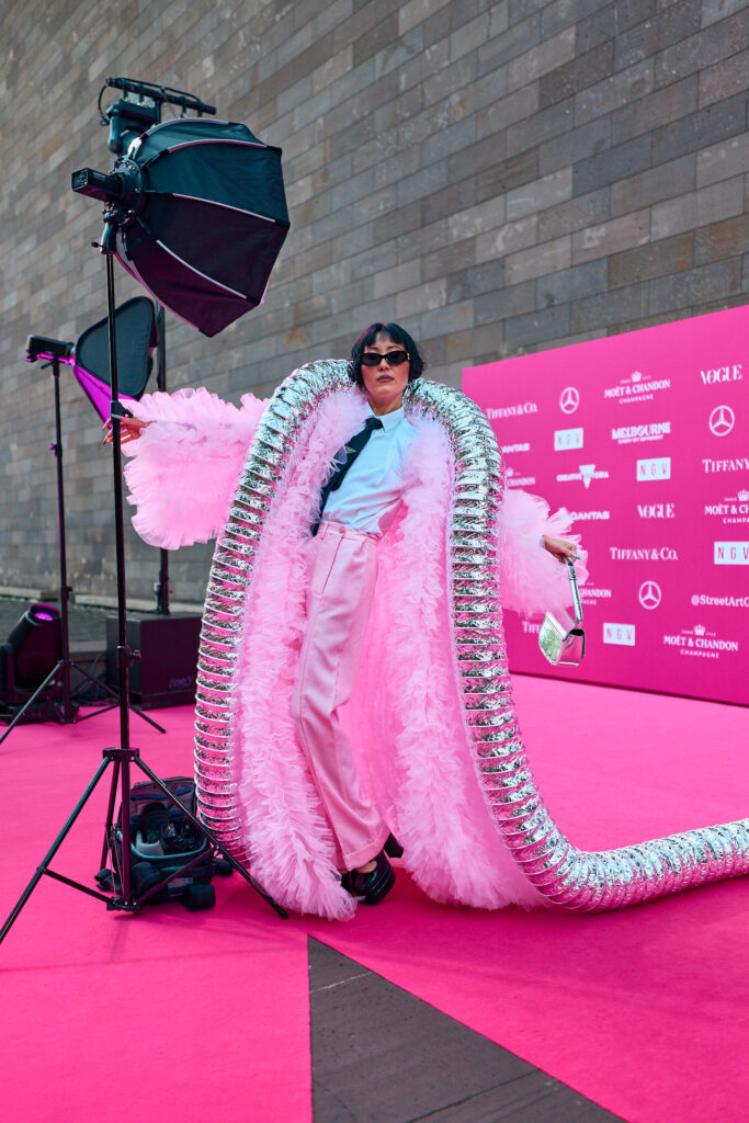 Charlene Ye Davis, Wearing a pink flamingo style jacket over the top of a White Business shirt and Prada Gabardine Tie, National Gallery of Victoria’s NGV GALA 2024. Chromatic Times Melbourne Fashion Photographer - Aidan McCorry