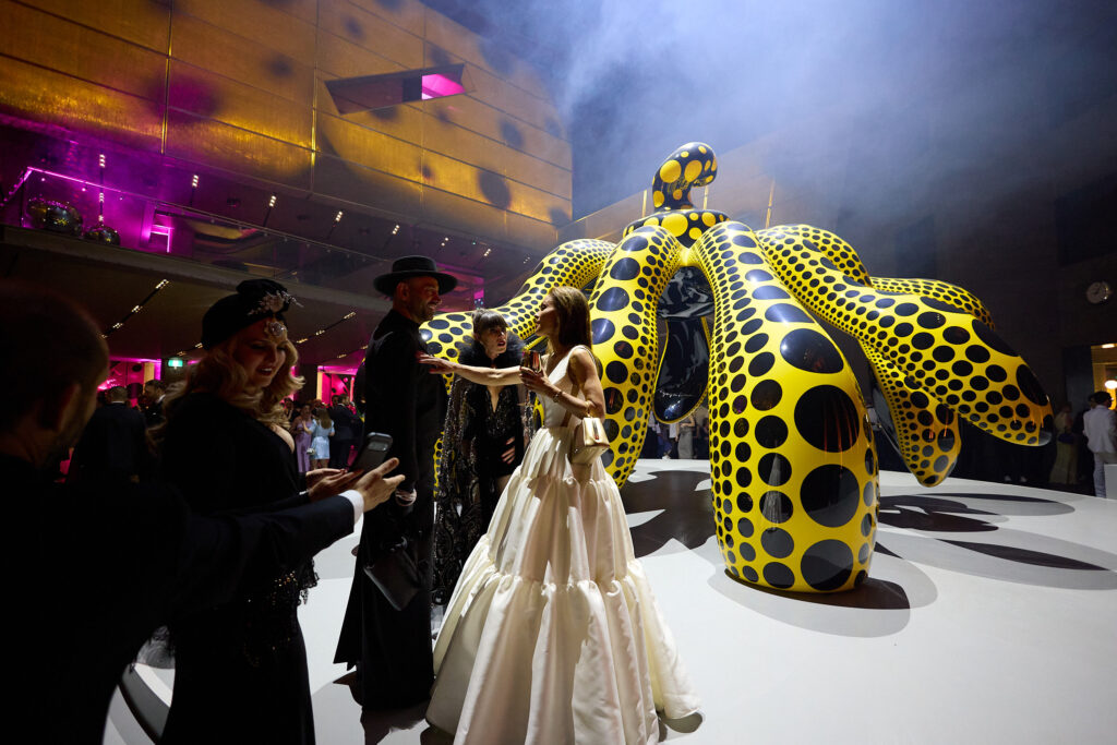 Designer Alin Le'kal Standing in front of Yayoi Kusama Sculpture Located at the foyer of NGV Melbourne for the Gala event. Taken by Aidan McCorry Fashion Photographer Chromatic Times